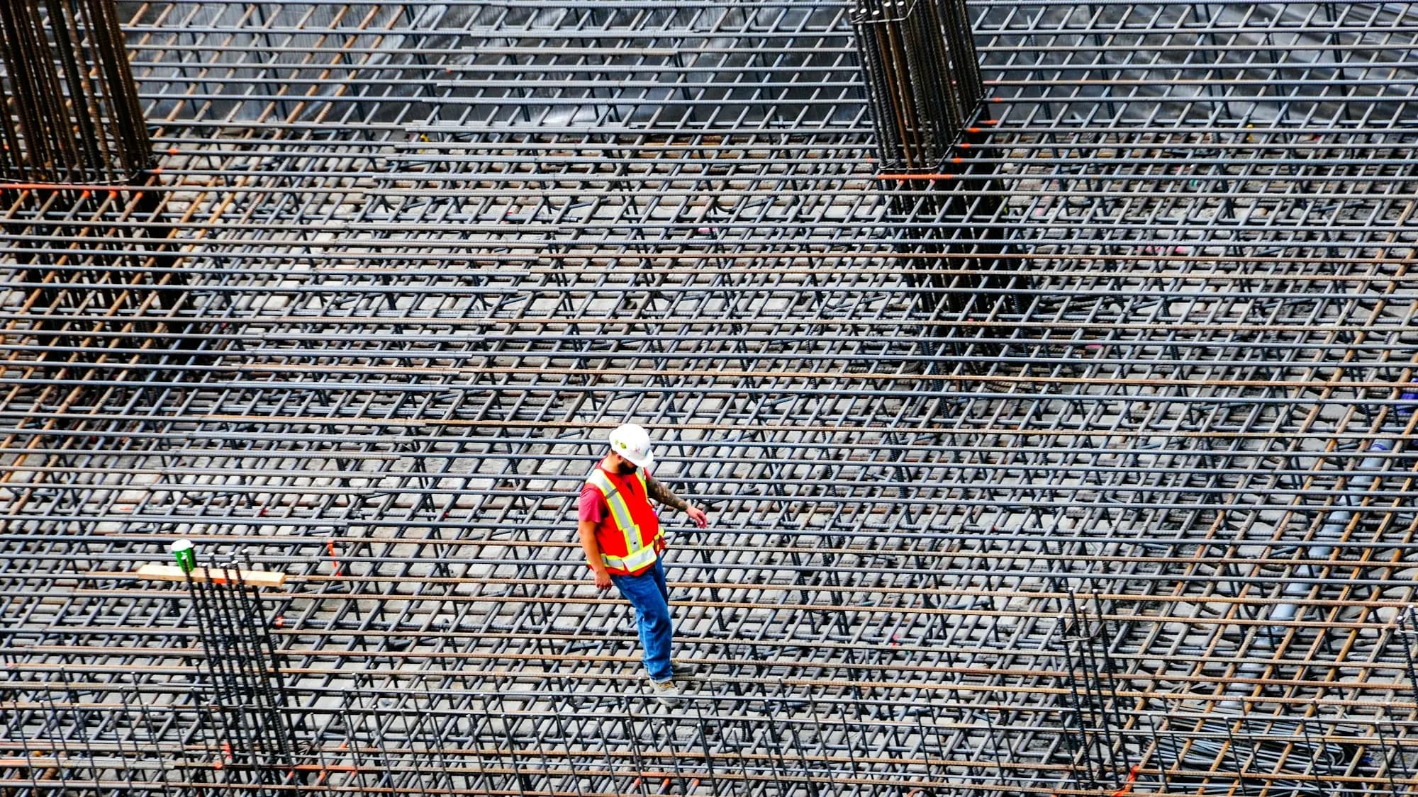 Large formed concrete slab with a compacted stone base and rebar ready for the pour