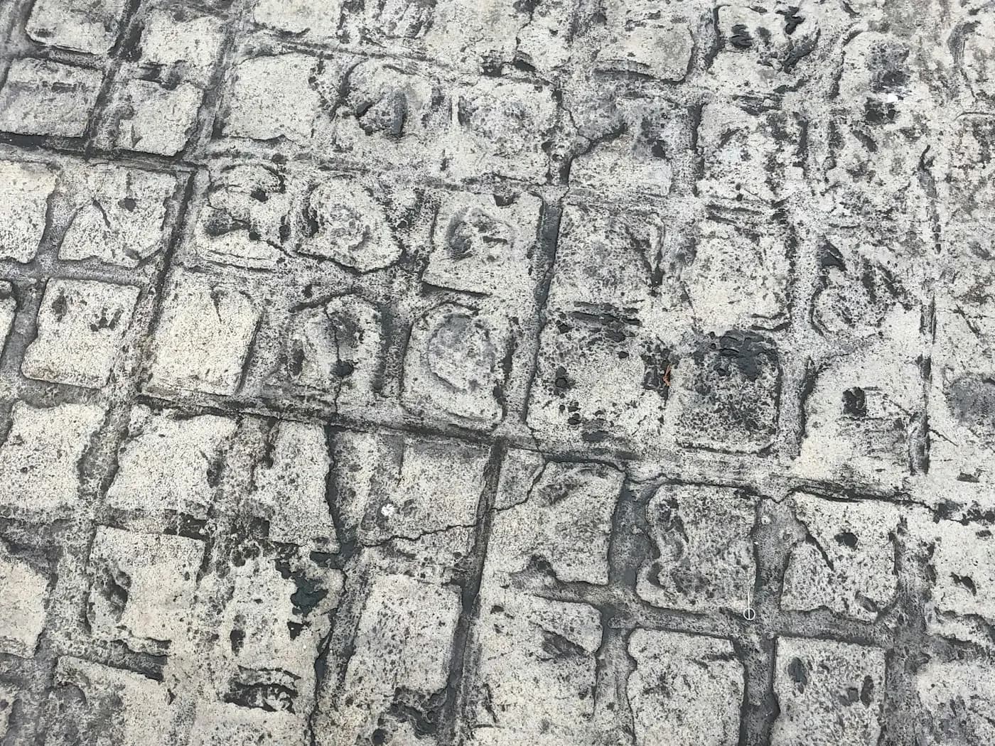 Grey and black patterned paving in a geometric layout