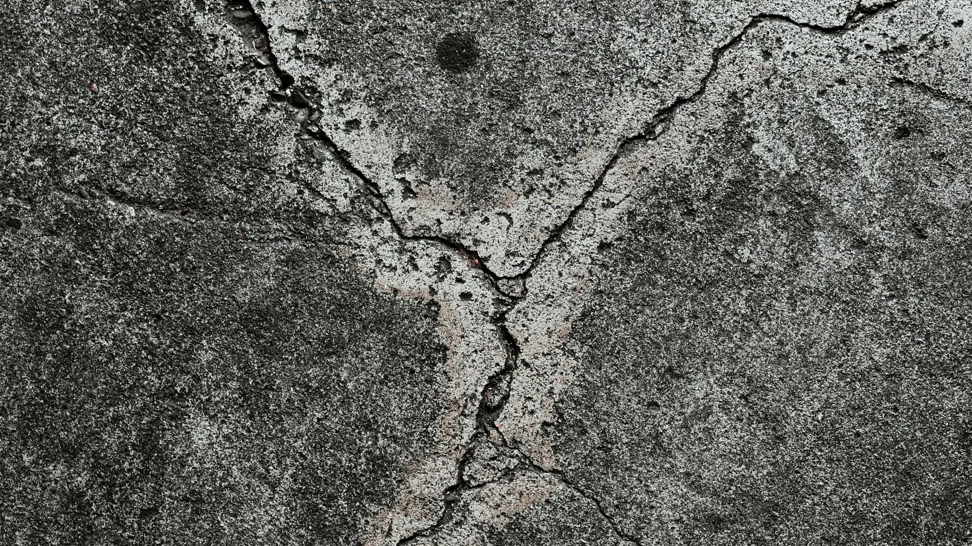 Close-up of a freshly broom-finished concrete surface in warm low light