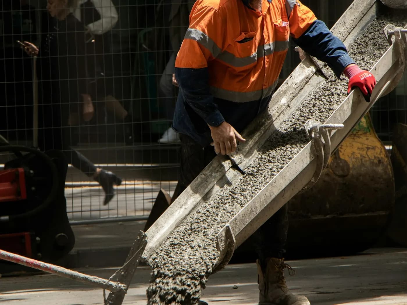 Concrete being poured and screeded on a commercial flatwork job