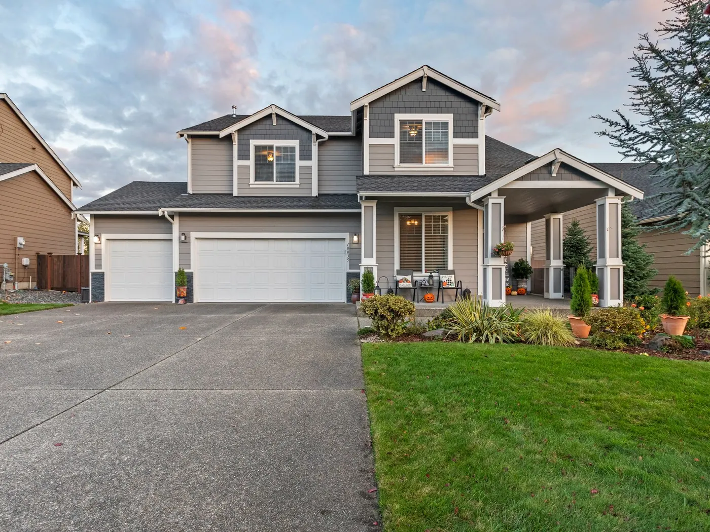 Concrete driveway serving a three-car garage on a suburban home