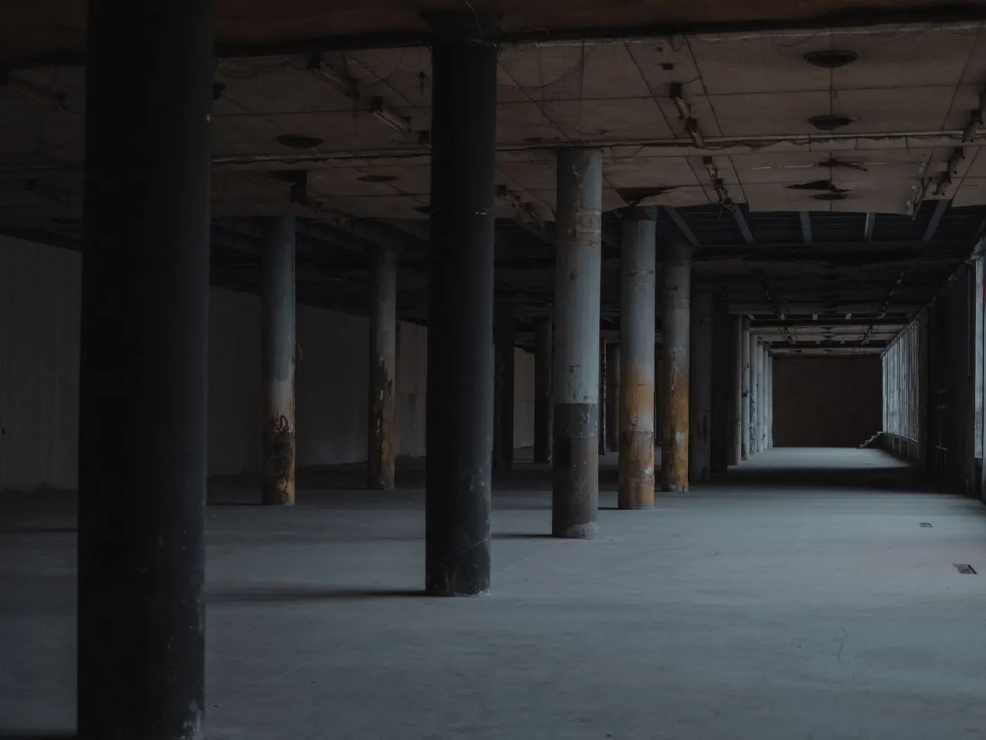 Bare concrete floor and columns in an empty basement level