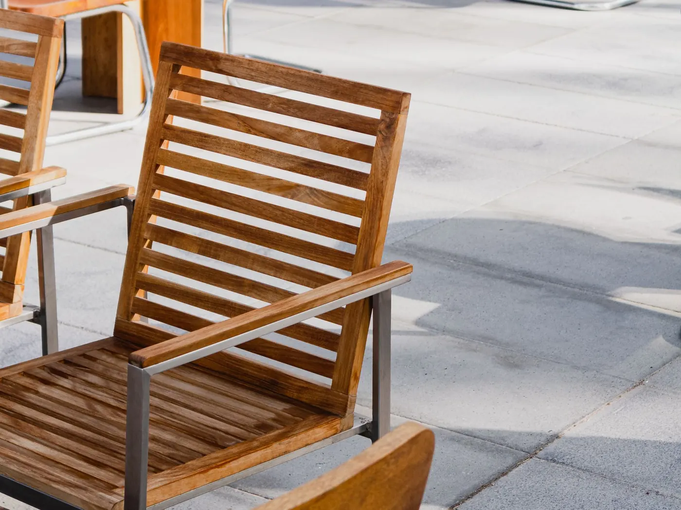 Wooden bench on a smooth broom-finished concrete patio
