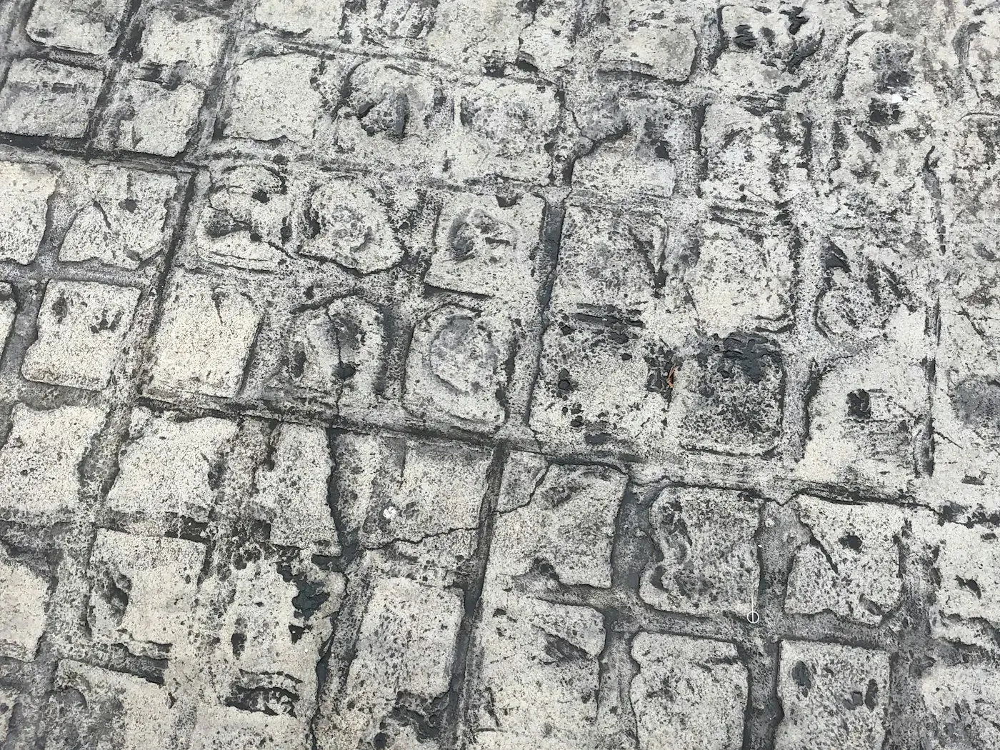 Grey and black patterned paving in a geometric layout
