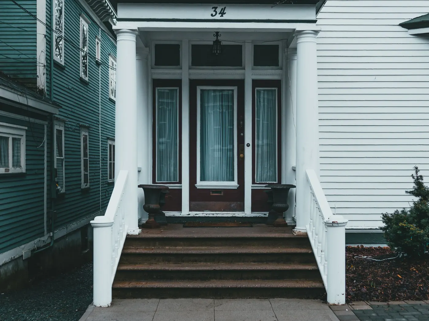 Front steps and landing at the entrance of a clapboard house