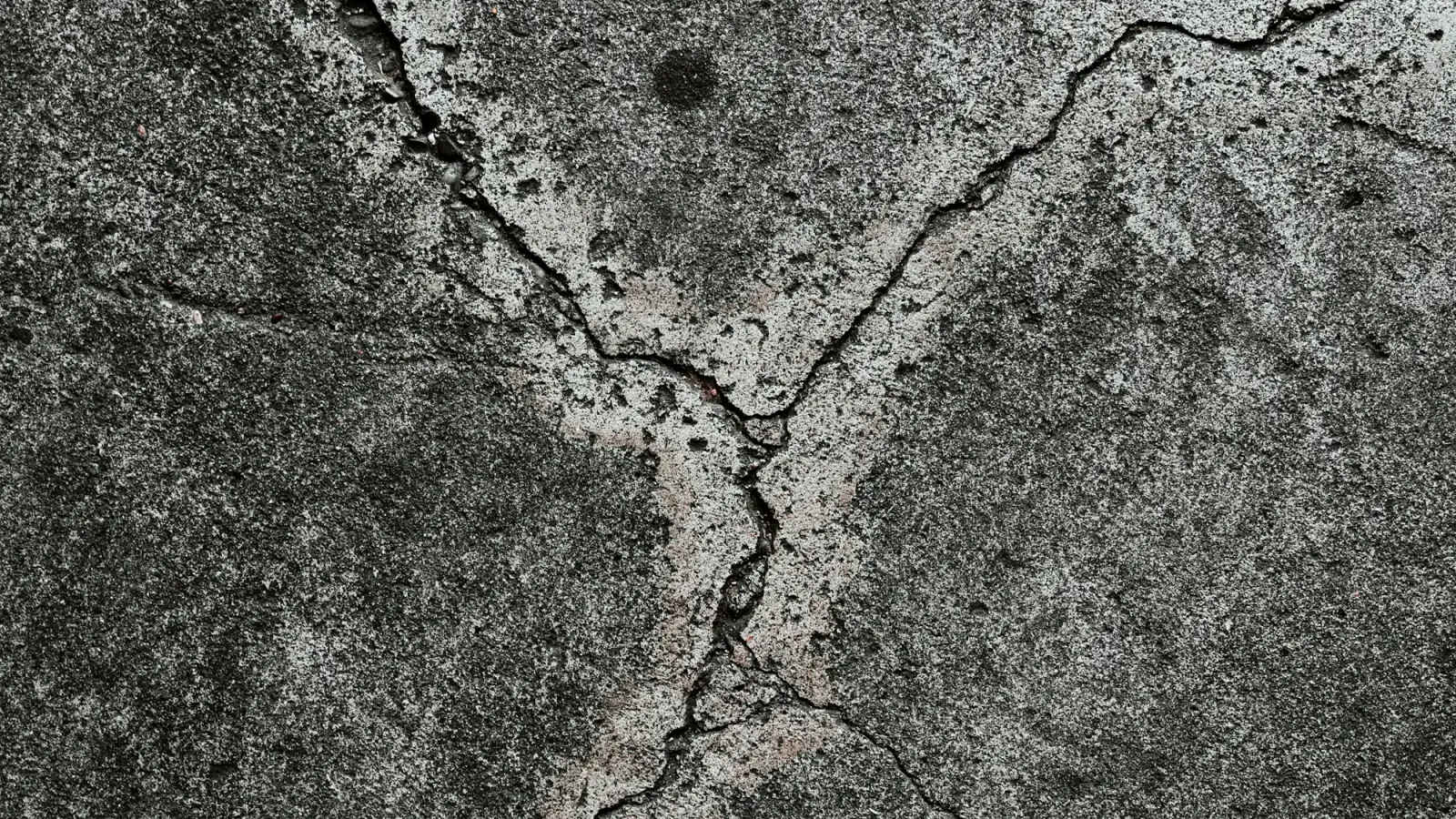 Close-up of a freshly broom-finished concrete surface in warm low light